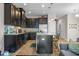 Modern kitchen features dark wood cabinetry, stainless steel appliances, and granite countertops at 150 Mitchell Creek Way, Oviedo, FL 32765