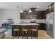 Spacious kitchen features dark cabinets, a granite island, and stainless steel appliances at 150 Mitchell Creek Way, Oviedo, FL 32765