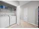 Well-lit laundry room with a washer and dryer and access to hallway at 150 Mitchell Creek Way, Oviedo, FL 32765