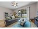 Comfortable living room features sliding glass doors leading to a backyard at 150 Mitchell Creek Way, Oviedo, FL 32765