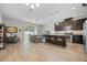 Bright open concept layout connecting the living room and kitchen with bar stool seating at the kitchen island at 150 Mitchell Creek Way, Oviedo, FL 32765