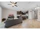 Bright open floor plan showcasing living area, kitchen island with barstools, and modern appliances at 150 Mitchell Creek Way, Oviedo, FL 32765