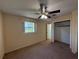 Bedroom featuring neutral walls, carpet floors, a closet, and a ceiling fan at 1506 Carmen Ave, Daytona Beach, FL 32117