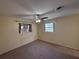 Bedroom with tan walls, carpeted floors, a window, and a ceiling fan for comfort at 1506 Carmen Ave, Daytona Beach, FL 32117