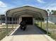 View of the carport leading to the garage with a motorcycle parked inside at 1506 Carmen Ave, Daytona Beach, FL 32117