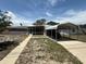 Charming single-story home featuring a carport and screened front porch at 1506 Carmen Ave, Daytona Beach, FL 32117