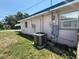 The exterior side of the house showing the AC Unit, utility boxes and window at 1506 Carmen Ave, Daytona Beach, FL 32117