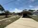 Quaint single-story home featuring a carport, driveway, and mature landscaping at 1506 Carmen Ave, Daytona Beach, FL 32117