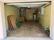 View of the home's empty garage with storage and access to interior at 1506 Carmen Ave, Daytona Beach, FL 32117