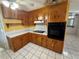 Well-lit kitchen featuring wooden cabinets, tile backsplash, and modern appliances at 1506 Carmen Ave, Daytona Beach, FL 32117