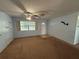 Cozy living room features a ceiling fan, window and tile entryway at 1506 Carmen Ave, Daytona Beach, FL 32117