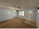 Spacious living room featuring carpeted floors, a ceiling fan, and a front door at 1506 Carmen Ave, Daytona Beach, FL 32117