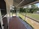 The covered patio has tiled flooring, screen door, and overlooks the backyard at 1506 Carmen Ave, Daytona Beach, FL 32117
