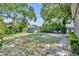 Wide shot of backyard with green lawn, brick patio, and storage shed; perfect for entertaining and play at 1511 Chestnut Ave, Winter Park, FL 32789