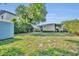 Expansive backyard featuring a storage shed, a well-maintained lawn, and a screened-in patio at 1511 Chestnut Ave, Winter Park, FL 32789