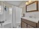 The bathroom features a vanity with a dark wood cabinet and a shower-tub combo at 1511 Chestnut Ave, Winter Park, FL 32789