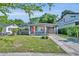 Charming single-story home featuring a quaint front porch, covered parking, and a well-maintained lawn at 1511 Chestnut Ave, Winter Park, FL 32789