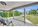 Charming front porch featuring tiled flooring, white columns, and a peaceful view at 1511 Chestnut Ave, Winter Park, FL 32789