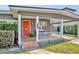 Welcoming front porch with a cozy seating area and an orange front door at 1511 Chestnut Ave, Winter Park, FL 32789