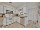 Cozy kitchen features white cabinets, tile floors, stainless dishwasher and recessed lighting at 1511 Chestnut Ave, Winter Park, FL 32789