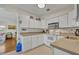 Bright kitchen boasts white cabinets, stainless steel appliances and tile floors at 1511 Chestnut Ave, Winter Park, FL 32789