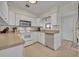 Well-lit kitchen featuring white cabinetry, stainless steel appliances, and tiled flooring at 1511 Chestnut Ave, Winter Park, FL 32789