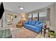 Inviting living room is furnished with plush blue sofa, leather armchair, and an area rug at 1511 Chestnut Ave, Winter Park, FL 32789
