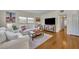 Bright living room with hardwood floors, a comfortable sofa, and lots of natural light at 1511 Chestnut Ave, Winter Park, FL 32789