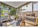 Relaxing screened patio with seating area, grill, and view of the lush backyard and storage shed at 1511 Chestnut Ave, Winter Park, FL 32789