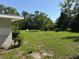 Large grassy backyard with scattered trees provides an ideal opportunity for outdoor activities and gatherings at 1526 Cordova Ave, Holly Hill, FL 32117