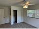 This bedroom has a ceiling fan, large windows, carpet flooring, and a closet at 1526 Cordova Ave, Holly Hill, FL 32117