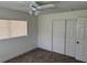 This bedroom has a ceiling fan, closet, window, and carpeted floor at 1526 Cordova Ave, Holly Hill, FL 32117