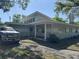 Inviting single-story home showcasing a covered front porch and well-manicured landscaping at 1526 Cordova Ave, Holly Hill, FL 32117