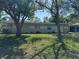 Charming single-story home featuring a well-maintained lawn and mature trees, exuding curb appeal and tranquility at 1526 Cordova Ave, Holly Hill, FL 32117