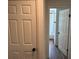 Hallway featuring a view of the bathroom and additional doors at 1526 Cordova Ave, Holly Hill, FL 32117