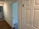 Hallway features wood floors and an open doorway leading into a carpeted room at 1526 Cordova Ave, Holly Hill, FL 32117