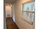 Hallway with wood-look flooring, leading to other rooms, and a window that provides natural light at 1526 Cordova Ave, Holly Hill, FL 32117