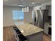 This is a well-lit kitchen, with an island that has a granite countertop and modern pendant lighting at 1526 Cordova Ave, Holly Hill, FL 32117