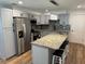 Open kitchen with granite island, stainless appliances, and modern cabinetry, perfect for entertaining at 1526 Cordova Ave, Holly Hill, FL 32117