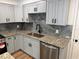 Contemporary kitchen boasting granite counters, stainless appliances, and sleek cabinetry at 1526 Cordova Ave, Holly Hill, FL 32117