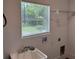 Laundry room with utility sink, window with blinds, and wire shelving at 1526 Cordova Ave, Holly Hill, FL 32117