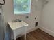 This laundry room has new wood floors, and a utility sink at 1526 Cordova Ave, Holly Hill, FL 32117