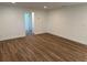 Spacious living room with wood flooring and a view to a hallway at 1526 Cordova Ave, Holly Hill, FL 32117