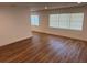 Spacious living room with new wood flooring and large windows at 1526 Cordova Ave, Holly Hill, FL 32117