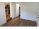 Bright living room featuring new wood flooring, neutral paint, and an open doorway to the kitchen at 1526 Cordova Ave, Holly Hill, FL 32117