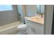 Bathroom featuring a tub, a shower, a toilet, and a vanity with a white countertop and backsplash at 15380 Sw 60Th Cir, Ocala, FL 34473
