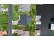Aerial view of a house, showcasing its well-maintained lawn, surrounding neighborhood, and proximity to a waterway at 1639 Yellow Brick Rd, Astor, FL 32102