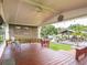 Enjoy the covered back porch, providing a serene outdoor living space with a ceiling fan at 1639 Yellow Brick Rd, Astor, FL 32102