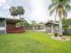 Property featuring a covered patio, wooden dock, and lush backyard, perfect for outdoor enjoyment at 1639 Yellow Brick Rd, Astor, FL 32102