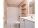 Bathroom with white tiled shower, modern vanity, and decorative wood shelves at 1639 Yellow Brick Rd, Astor, FL 32102